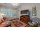 Comfortable living room with a large TV, hardwood floors, and a ceiling fan at 180 Winecoff Dr, Fayetteville, GA 30214