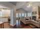 Living room open to the kitchen, with a fireplace and vaulted ceilings at 180 Winecoff Dr, Fayetteville, GA 30214