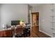 Neutral toned office with a desk, chair, hardwood floors and a walk-in closet to let in natural light at 180 Winecoff Dr, Fayetteville, GA 30214