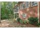 Brick home with screened porch and a stone garden in a wooded backyard at 180 Winecoff Dr, Fayetteville, GA 30214