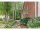 Brick home with a rock garden, trees, and a peaceful backyard setting at 180 Winecoff Dr, Fayetteville, GA 30214