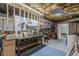 Unfinished basement with exposed ceiling, workbench, and shelving at 180 Winecoff Dr, Fayetteville, GA 30214