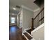 Welcoming entryway featuring wood floors, stairs with iron railings and a white front door at 184 Vinca Nw Cir, Kennesaw, GA 30144