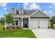 Charming one-story home with gray siding, white trim, a well-manicured lawn, and a two-car garage at 184 Vinca Nw Cir, Kennesaw, GA 30144