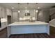 Modern kitchen featuring a large island with quartz countertops, white cabinets, and stainless steel appliances at 184 Vinca Nw Cir, Kennesaw, GA 30144