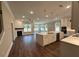 Open-concept kitchen and living room with a large island, fireplace, and lots of natural light at 184 Vinca Nw Cir, Kennesaw, GA 30144