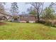 View of the backyard, featuring a brick house, steps, and lawn at 1561 Rupert Rd, Decatur, GA 30032