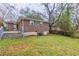 View of the backyard, featuring a brick house, steps, and lawn at 1561 Rupert Rd, Decatur, GA 30032