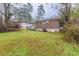 View of the backyard, featuring a brick house, steps, and lawn at 1561 Rupert Rd, Decatur, GA 30032