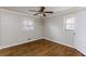 Bright bedroom features hardwood floors, two windows and ceiling fan at 1561 Rupert Rd, Decatur, GA 30032
