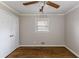 Cozy bedroom with hardwood floors, a ceiling fan, a closet, and a window at 1561 Rupert Rd, Decatur, GA 30032