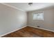 Neutral bedroom featuring hardwood floors and natural light from a window at 1561 Rupert Rd, Decatur, GA 30032