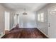 Inviting dining room with neutral walls, modern chandelier, and laminate flooring at 1561 Rupert Rd, Decatur, GA 30032