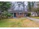 Charming single-story brick home with a cozy carport and mature trees in a quiet neighborhood at 1561 Rupert Rd, Decatur, GA 30032