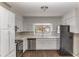 Well-lit kitchen featuring white cabinets, modern appliances, and ample counter space for cooking at 1561 Rupert Rd, Decatur, GA 30032