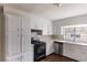 Functional kitchen showcasing white cabinets, an oven range, stainless steel dishwasher, and natural light at 1561 Rupert Rd, Decatur, GA 30032