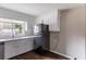 Bright kitchen featuring a black refrigerator, neutral countertops, and a window above the sink at 1561 Rupert Rd, Decatur, GA 30032