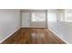 Bright living room with hardwood floors, a large window with natural light, and neutral paint at 1561 Rupert Rd, Decatur, GA 30032