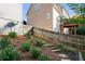 Backyard view of tiered landscaping with stone steps next to a wood fence at 315 Hunters Trce, Dallas, GA 30157