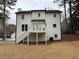 Exterior view of the home featuring a white deck with stairs in the backyard with an AC unit at 3663 Heatherwood Ne Dr, Marietta, GA 30066