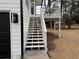 Exterior view of the home featuring white stairs leading to a deck in the backyard at 3663 Heatherwood Ne Dr, Marietta, GA 30066