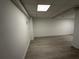 Unfinished basement with light gray wood floors, overhead lighting, and white walls at 3663 Heatherwood Ne Dr, Marietta, GA 30066