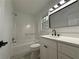 Modern bathroom with a tub and shower, sleek vanity, and contemporary fixtures at 3663 Heatherwood Ne Dr, Marietta, GA 30066