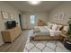 Bright bedroom features neutral walls, light hardwood floors, bench seat, and a large window at 3663 Heatherwood Ne Dr, Marietta, GA 30066