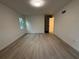 Empty bedroom with wood-look floors, a neutral color scheme, and a window offering natural light at 3663 Heatherwood Ne Dr, Marietta, GA 30066