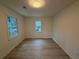 Bright bedroom featuring hardwood floors, white walls and natural light from two windows at 3663 Heatherwood Ne Dr, Marietta, GA 30066