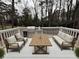 Relaxing deck with white railings, wood furniture, an outdoor kitchen, and a grill surrounded by trees at 3663 Heatherwood Ne Dr, Marietta, GA 30066