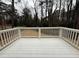 An elevated deck with white railing overlooks a woodsy landscape at 3663 Heatherwood Ne Dr, Marietta, GA 30066