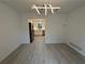 Bright dining area with gray wood floors, a modern light fixture, and an open doorway to the kitchen at 3663 Heatherwood Ne Dr, Marietta, GA 30066