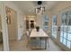 Bright dining area with a marble table, modern lighting fixture, and a view to the deck at 3663 Heatherwood Ne Dr, Marietta, GA 30066
