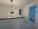 Hallway featuring a modern light fixture, grey handrail, and doors leading to other rooms at 3663 Heatherwood Ne Dr, Marietta, GA 30066