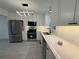 Open kitchen with updated stainless appliances and stylish decorative light fixture at 3663 Heatherwood Ne Dr, Marietta, GA 30066