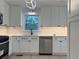 Modern kitchen with stainless steel appliances, white cabinets, and stylish light fixture at 3663 Heatherwood Ne Dr, Marietta, GA 30066