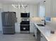 Remodeled kitchen with stainless appliances, white cabinets, and a modern sink fixture at 3663 Heatherwood Ne Dr, Marietta, GA 30066