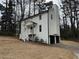 Rear view of home with attached two car garage, steps to front door at 3663 Heatherwood Ne Dr, Marietta, GA 30066