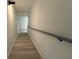 A stairwell featuring gray wood stairs, white walls, and a black handrail with black modern lighting at 3663 Heatherwood Ne Dr, Marietta, GA 30066