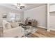 Comfortable living room with a ceiling fan, coffee table, and neutral toned furniture at 253 Beau St, Lilburn, GA 30047