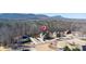 Aerial view of a home with a prominent map pin icon displayed above; mountains in the background at 4095 Copper Leaf Ln, Cumming, GA 30040