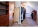Spacious walk-in closet featuring shelving, hanging racks, large mirror and extra storage for a tidy wardrobe at 4095 Copper Leaf Ln, Cumming, GA 30040