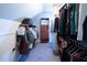 Walk-in closet with custom shelving, clothing racks, and ample storage space for an organized wardrobe at 4095 Copper Leaf Ln, Cumming, GA 30040