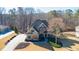 Aerial view of a well-manicured lawn and two-story home with a stone-accented facade at 4095 Copper Leaf Ln, Cumming, GA 30040