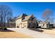 Exterior side view featuring a long driveway and basketball hoop at 4095 Copper Leaf Ln, Cumming, GA 30040