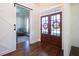 Warm and inviting front entry featuring gorgeous wooden flooring and a glass paneled door at 4095 Copper Leaf Ln, Cumming, GA 30040