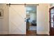 Interior view of a home office that is behind a sliding barn door at 4095 Copper Leaf Ln, Cumming, GA 30040