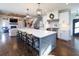 Modern kitchen design with a large kitchen island, stainless steel appliances, and hardwood floors at 4095 Copper Leaf Ln, Cumming, GA 30040