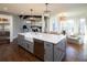Modern kitchen boasts a large island, stainless steel appliances, hardwood floors, and an open layout at 4095 Copper Leaf Ln, Cumming, GA 30040